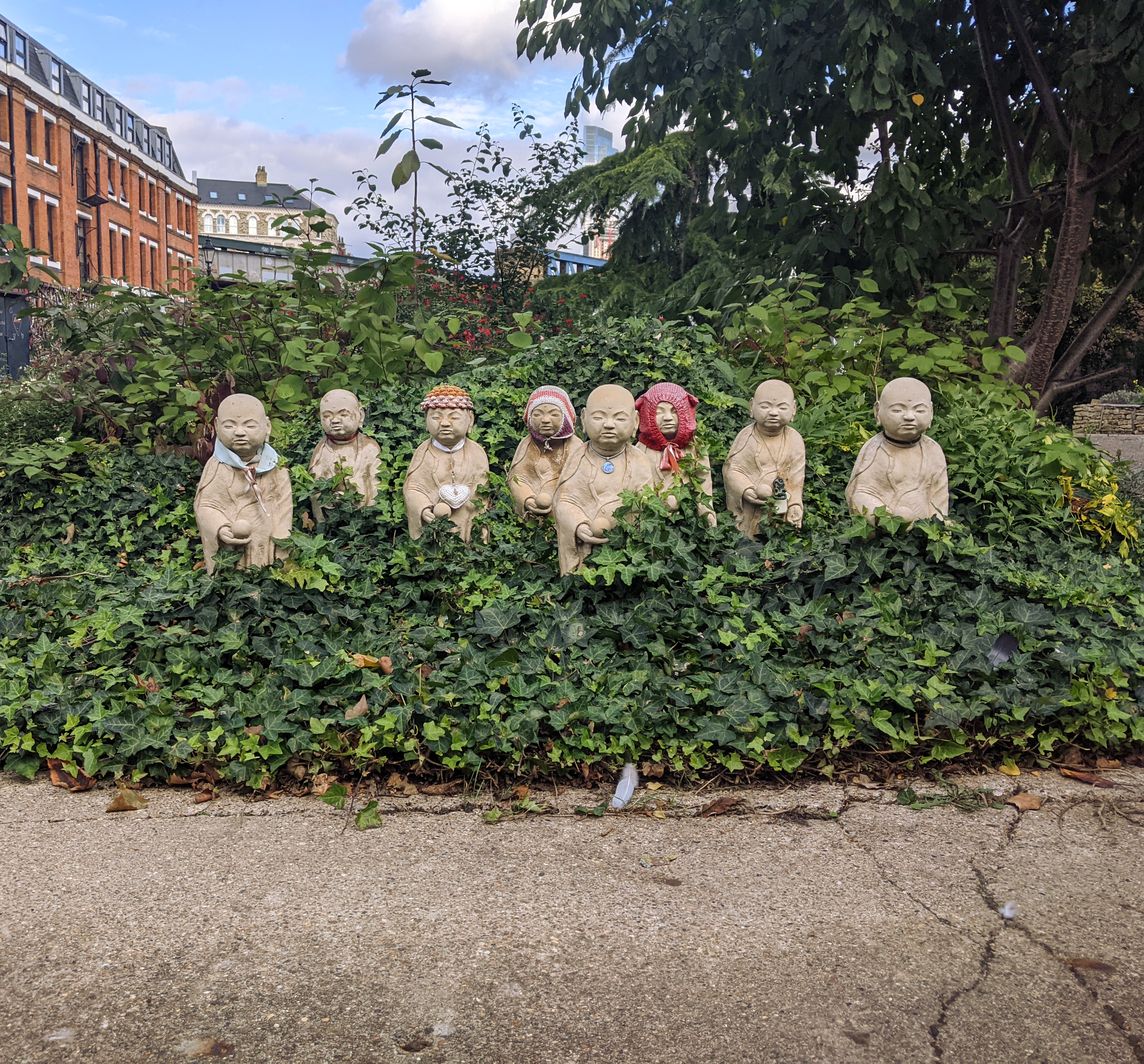 A photograph of the group of Mizuko Jizos, showing signs of age