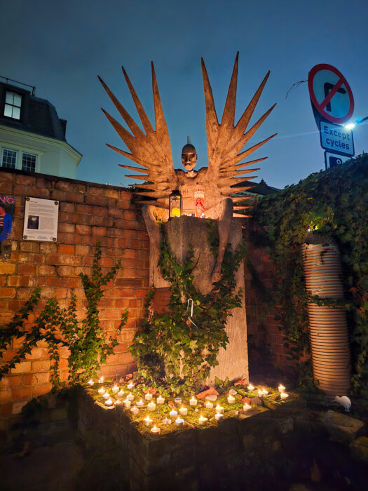 The Trans-Angel sculpture lit up by candles